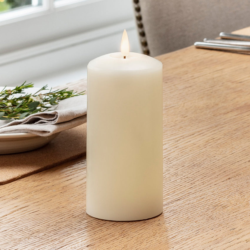 Flickering LED candle on table