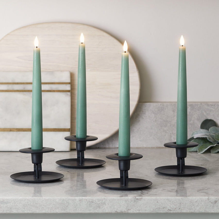 LED taper candles in green on a kitchen surface