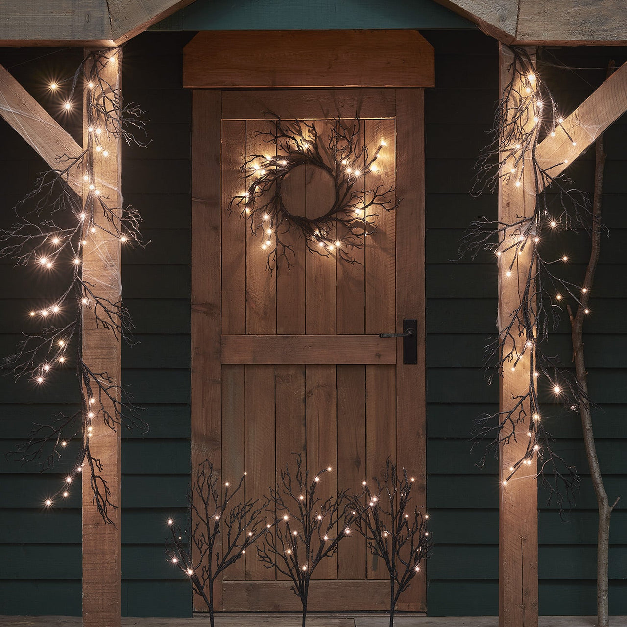 D-HA2300234_Pre-Lit-Black-Glitter-Halloween-Wreath-Garland-_-Stake-Lights.jpg