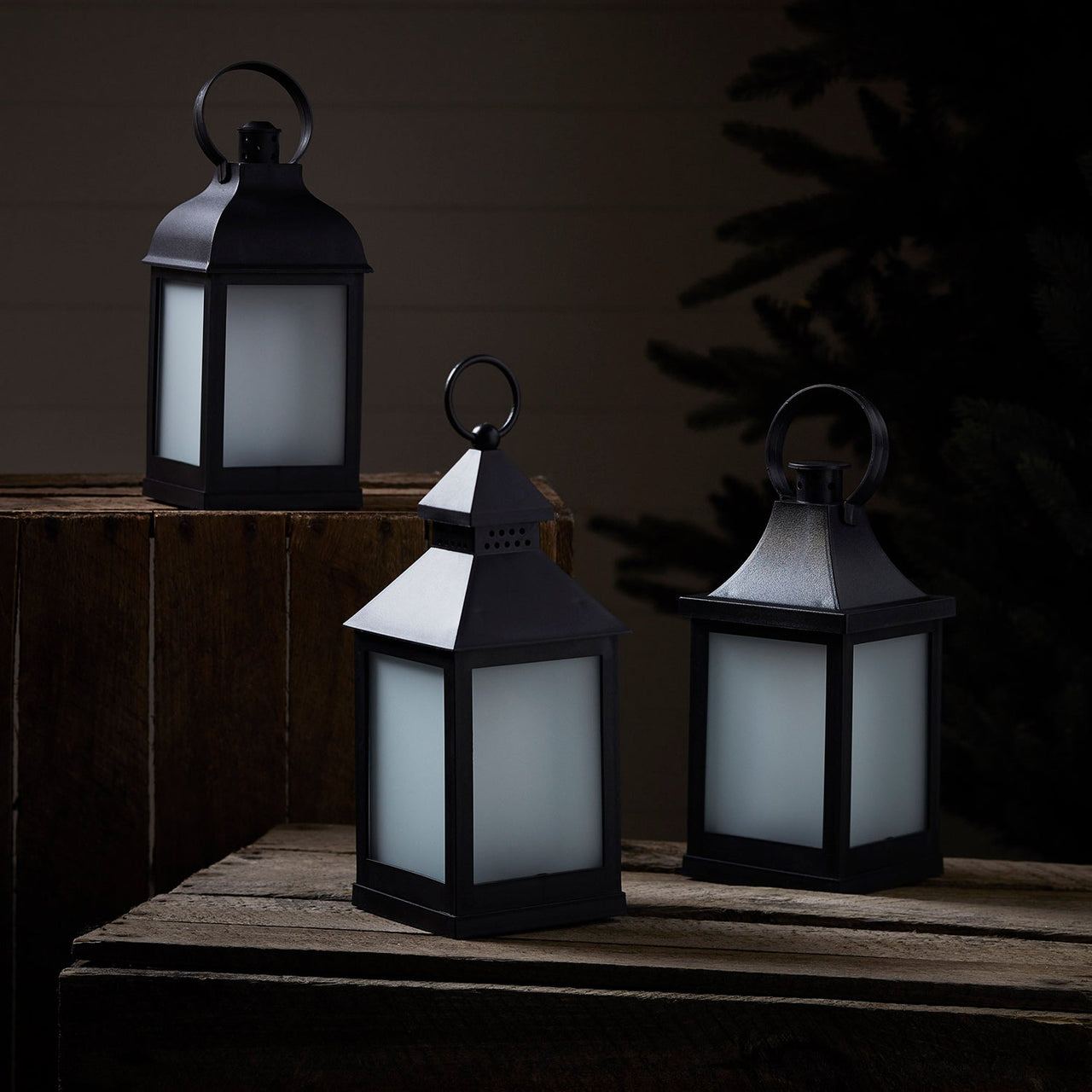 LA19013_3-Flame-Effect-Garden-Lanterns-In-A-Night-Time-Setting-Off.jpg