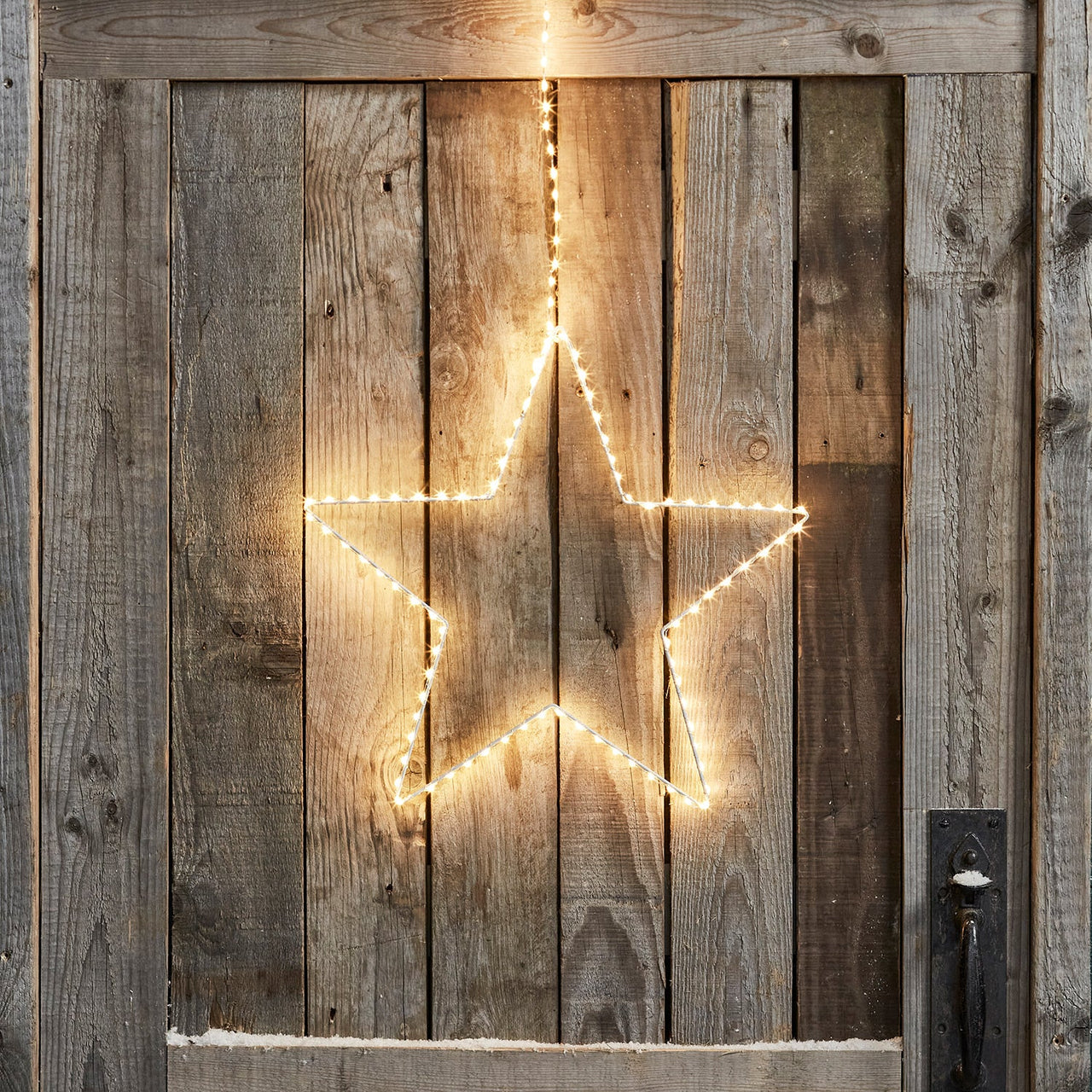 PL21047_Outdoor-Christmas-LED-Hanging-Star-Lights-Cabin-Door-Close-Illuminated.jpg