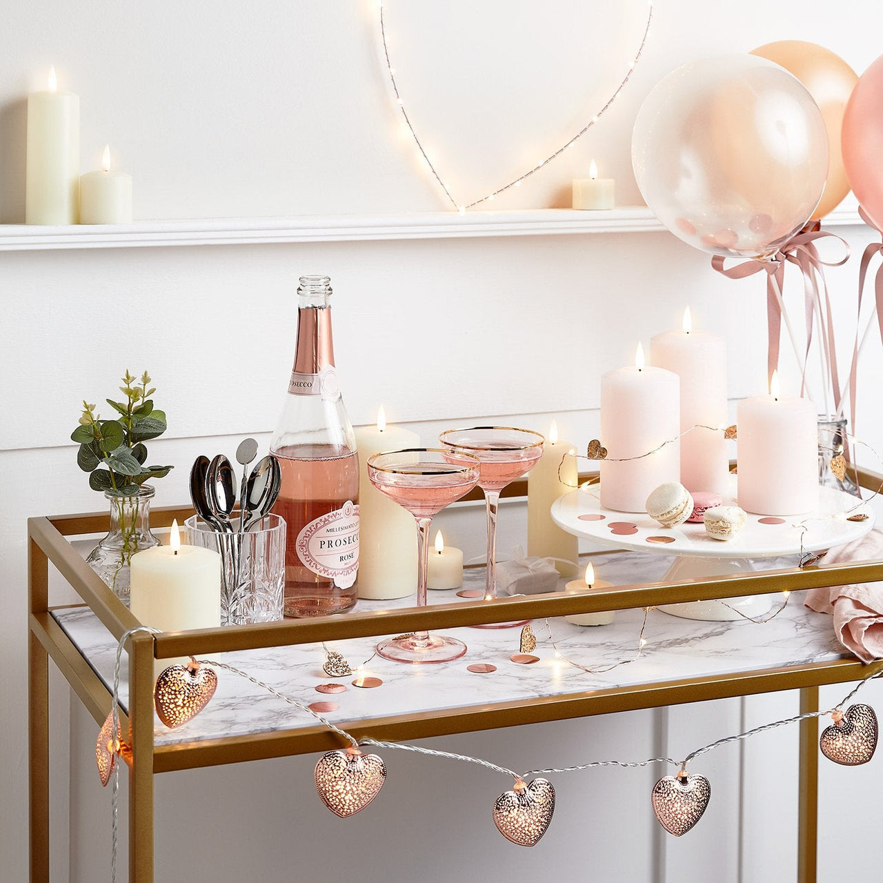 Valentines-Table-Setting-Pink-Prosecco-Bottle-Open-Glasses-Filled-Heart-String-Lights-LED-TruGlow-Candles-Pink-Balloons-LED-Micro-Heart-Shelf_845866c8-0ccf-47a1-9f64-915ac26149cb.jpg